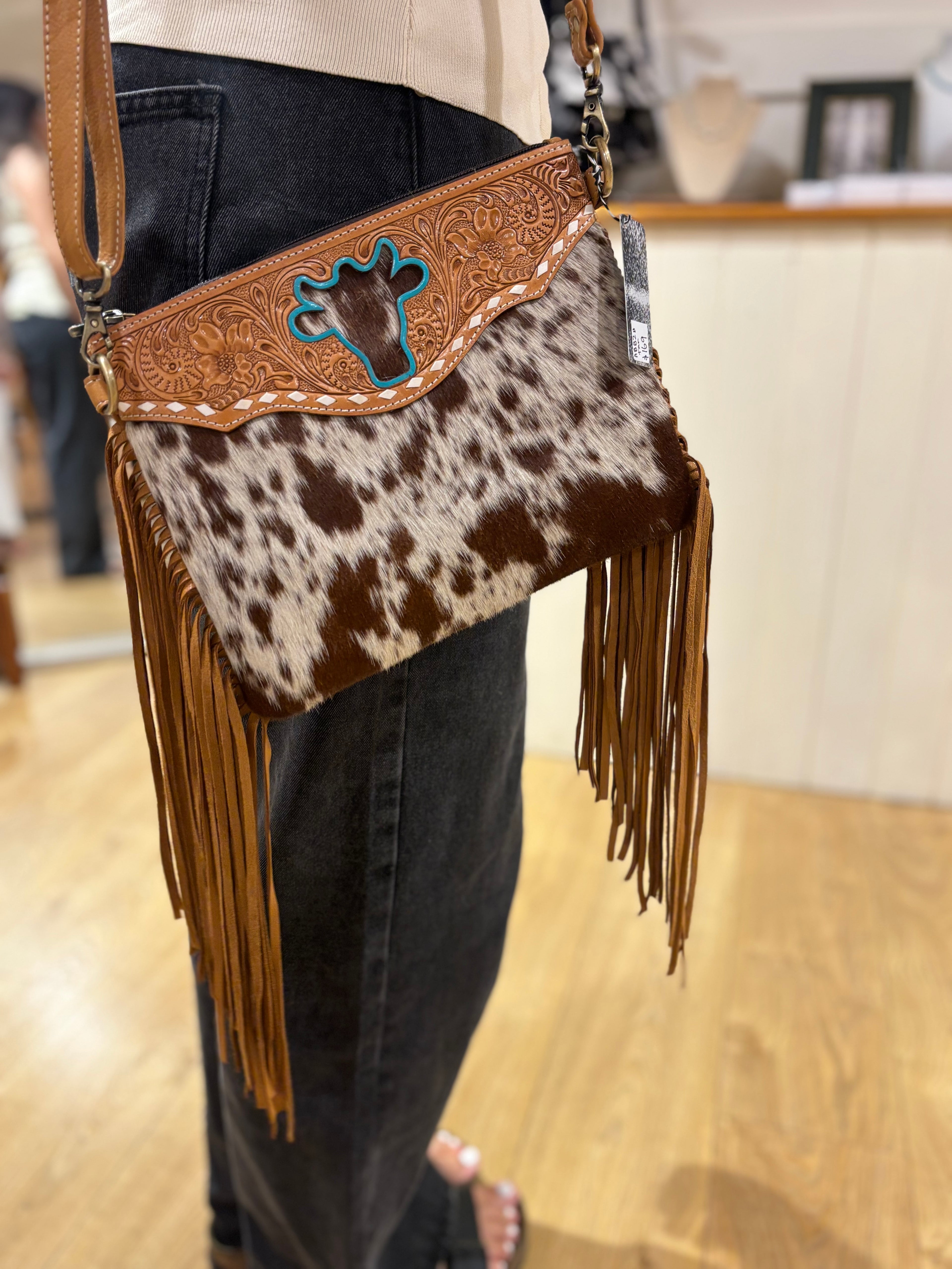 Bullhead cowhide sling bag with fringes