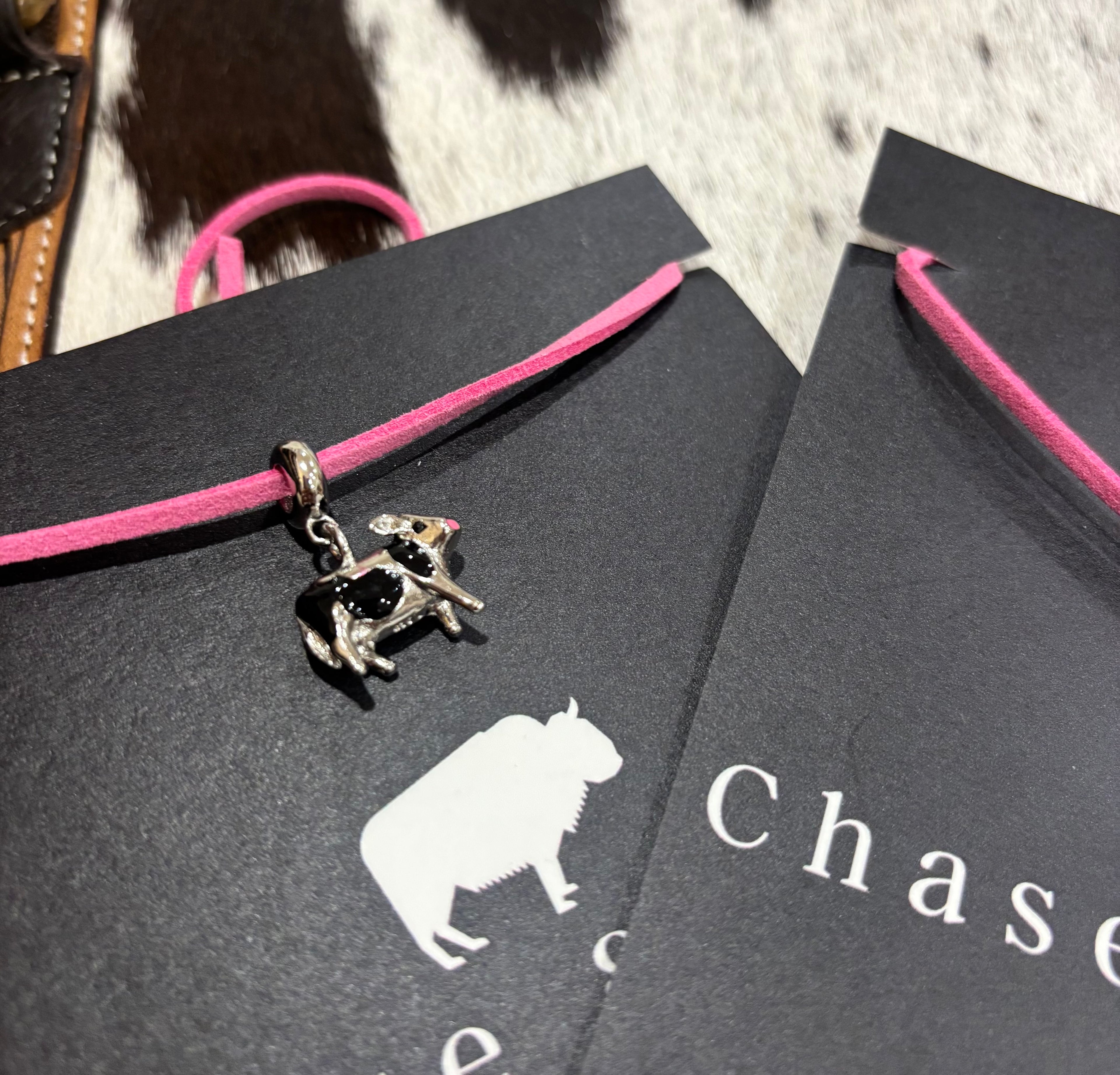 Silver Cows charm on pink leather lariat