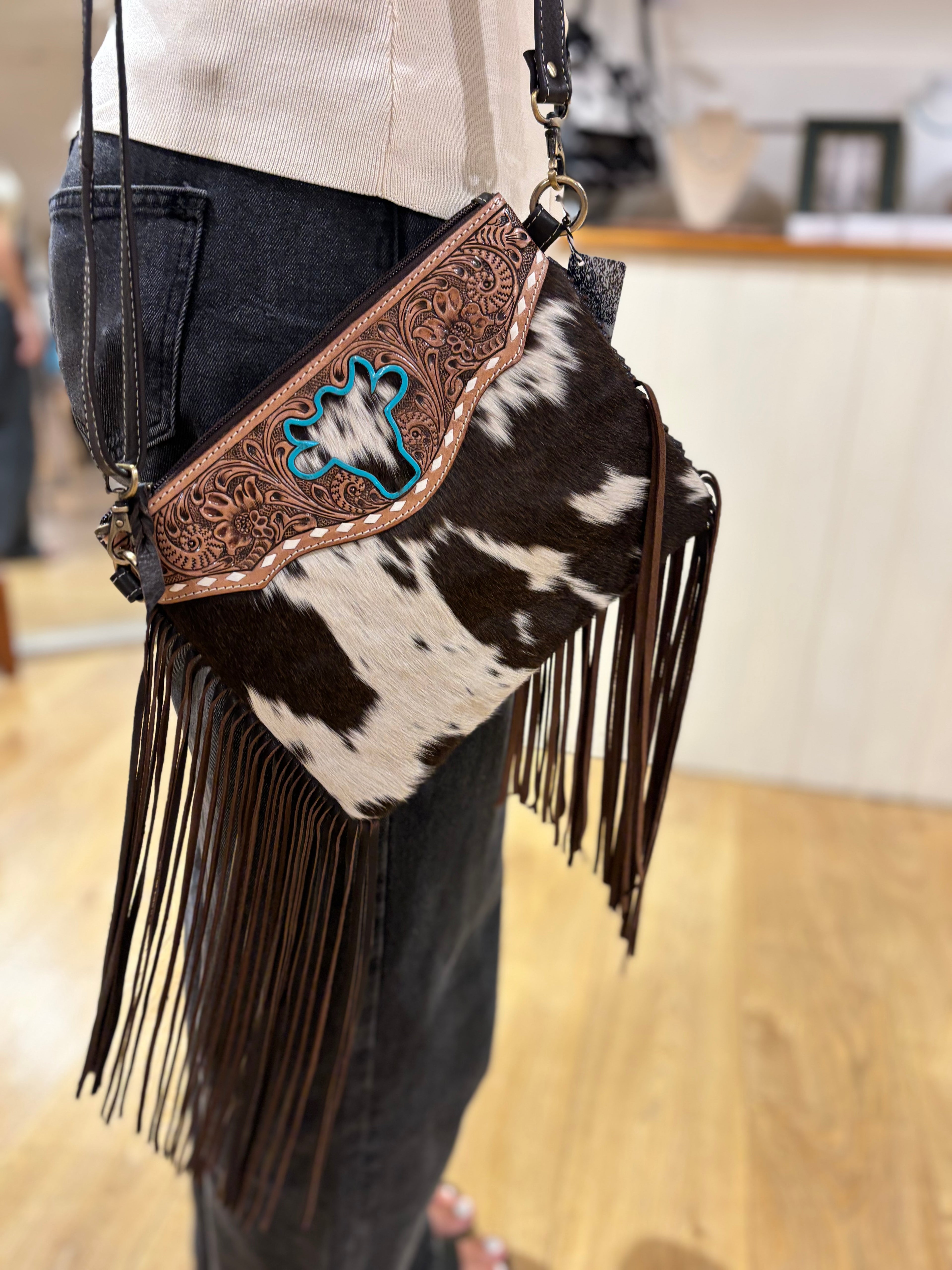 Bullhead cowhide sling bag with fringes