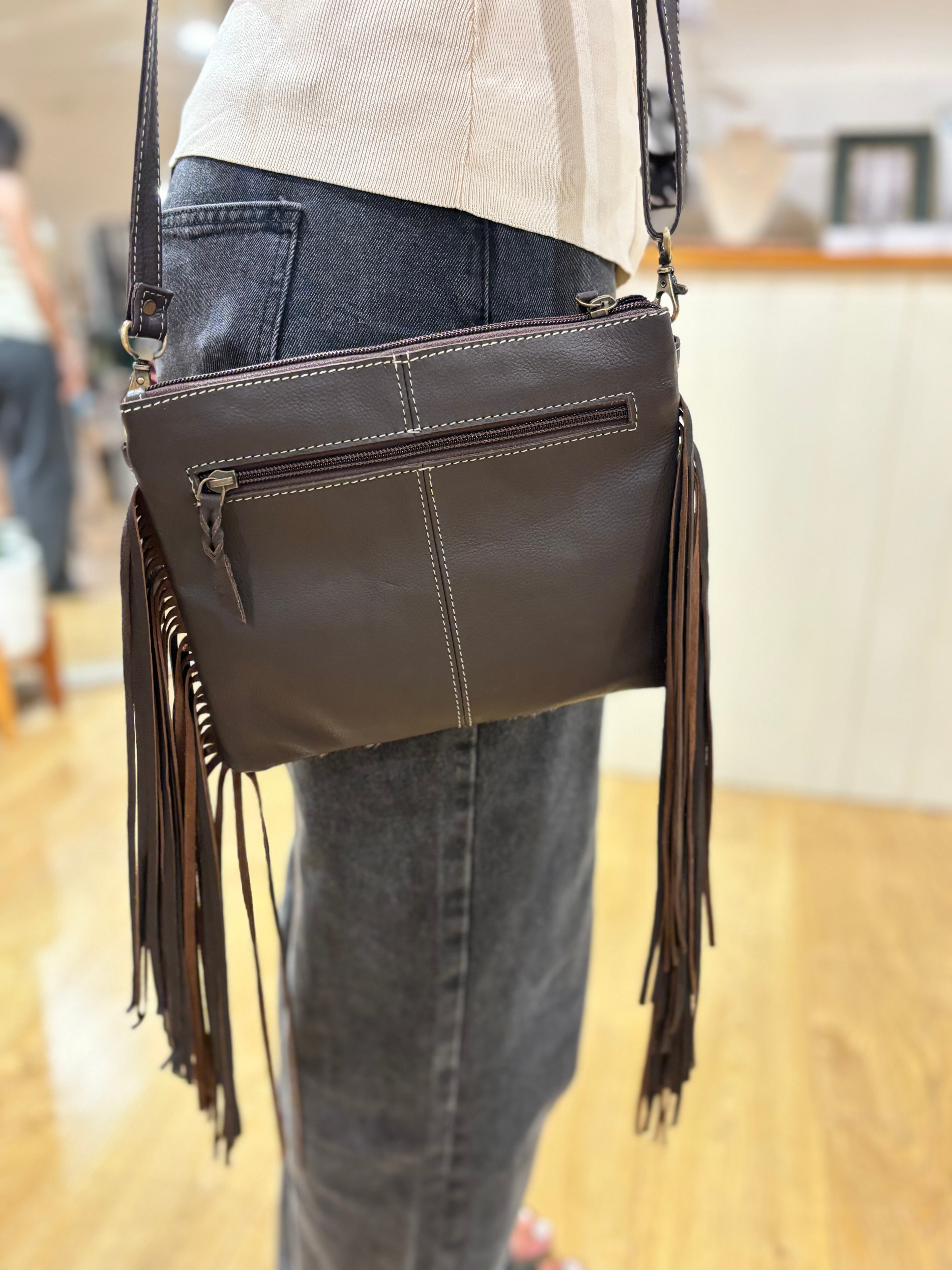 Bullhead cowhide sling bag with fringes
