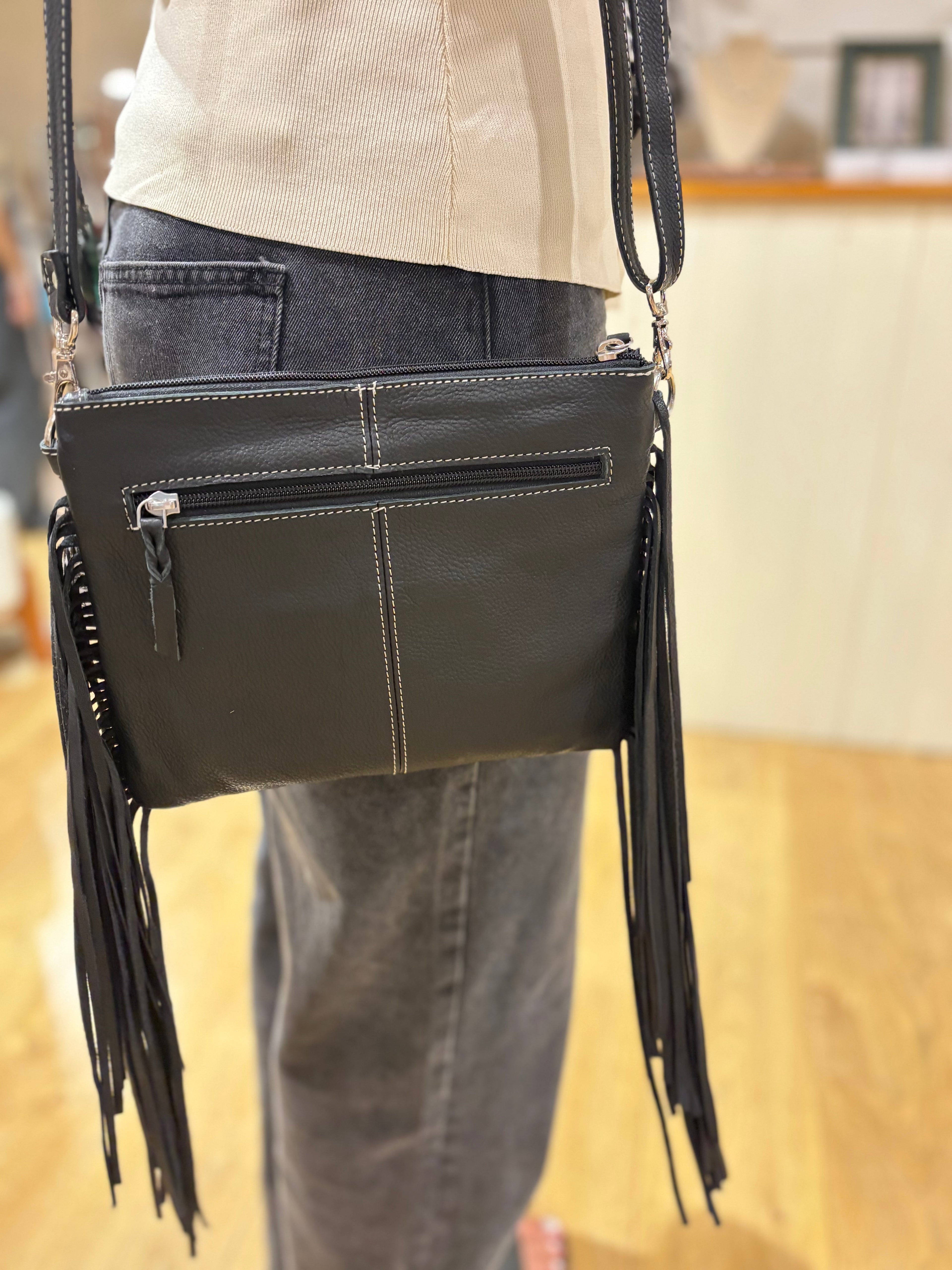 Bullhead cowhide sling bag with fringes