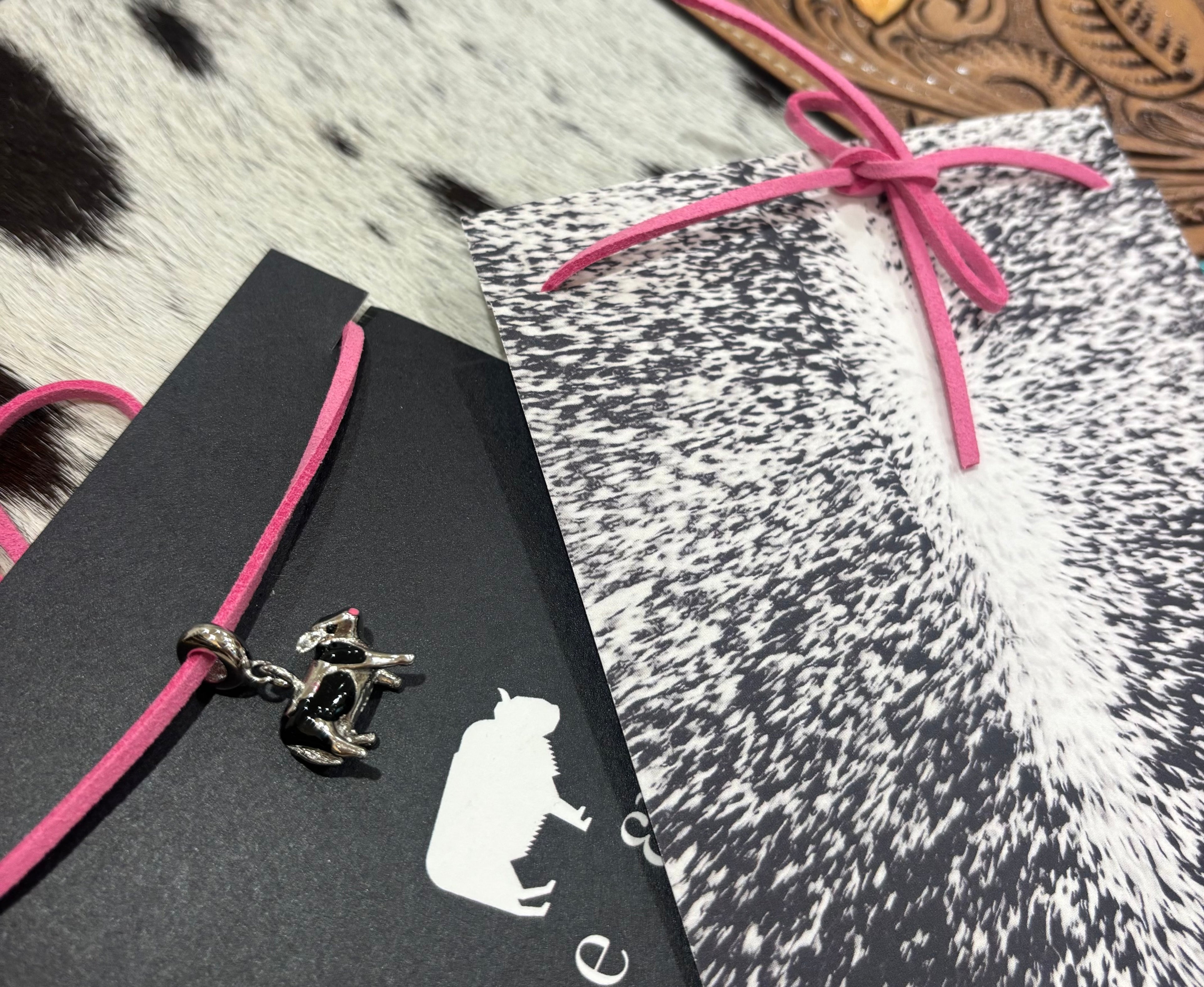 Silver Cows charm on pink leather lariat