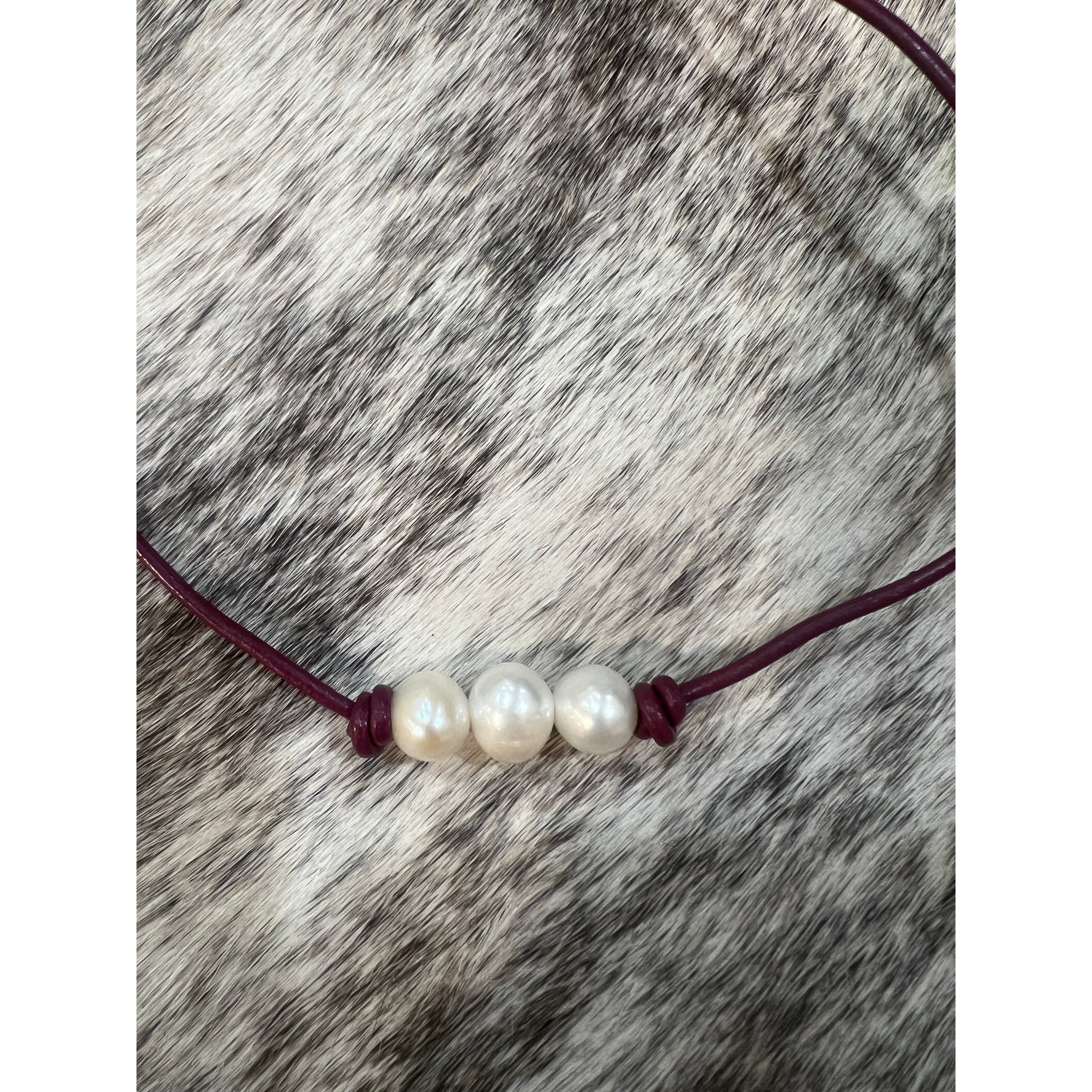 Pearls on maroon leather