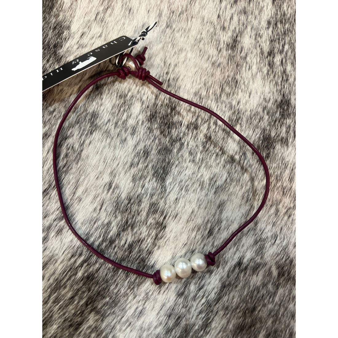 Pearls on maroon leather