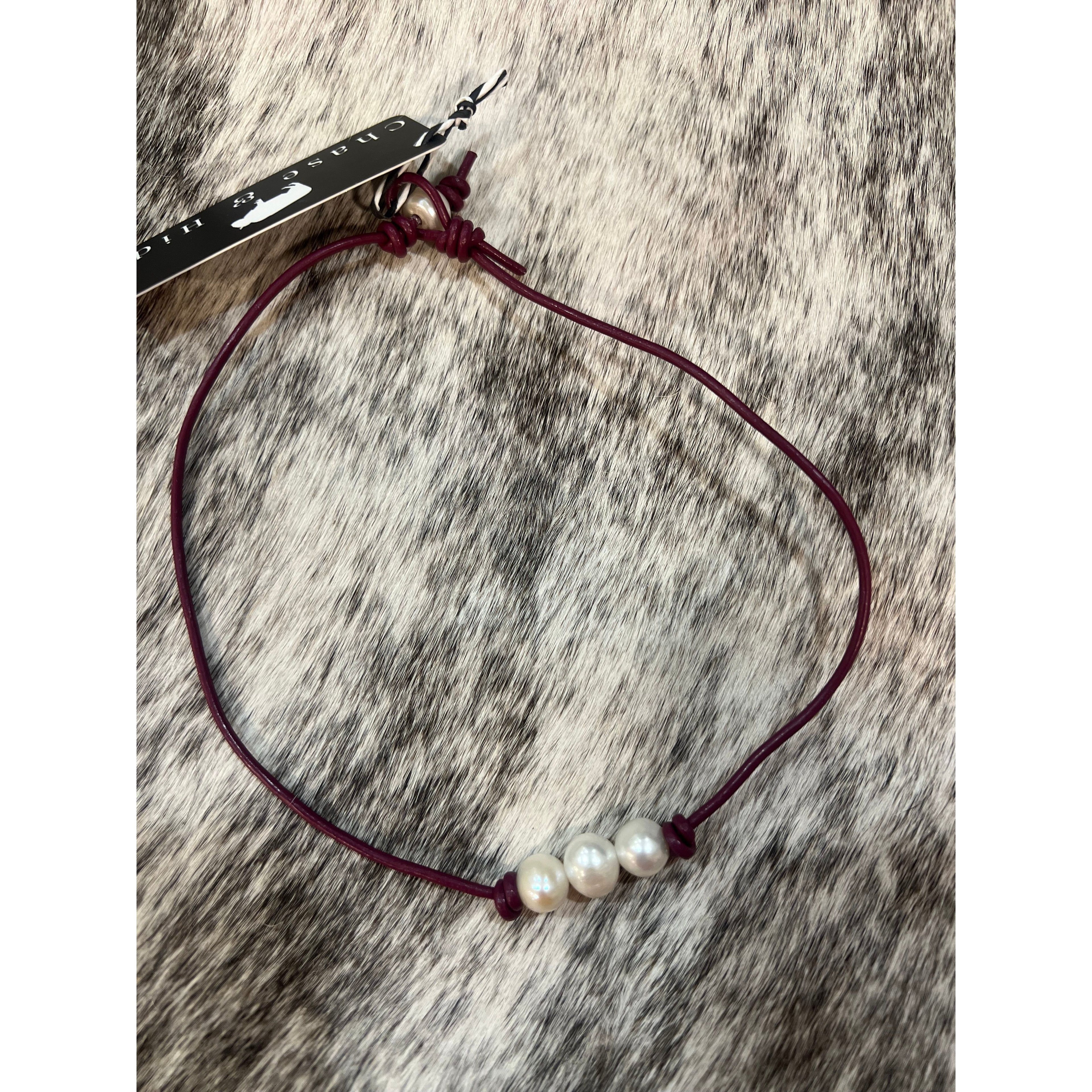 Pearls on maroon leather