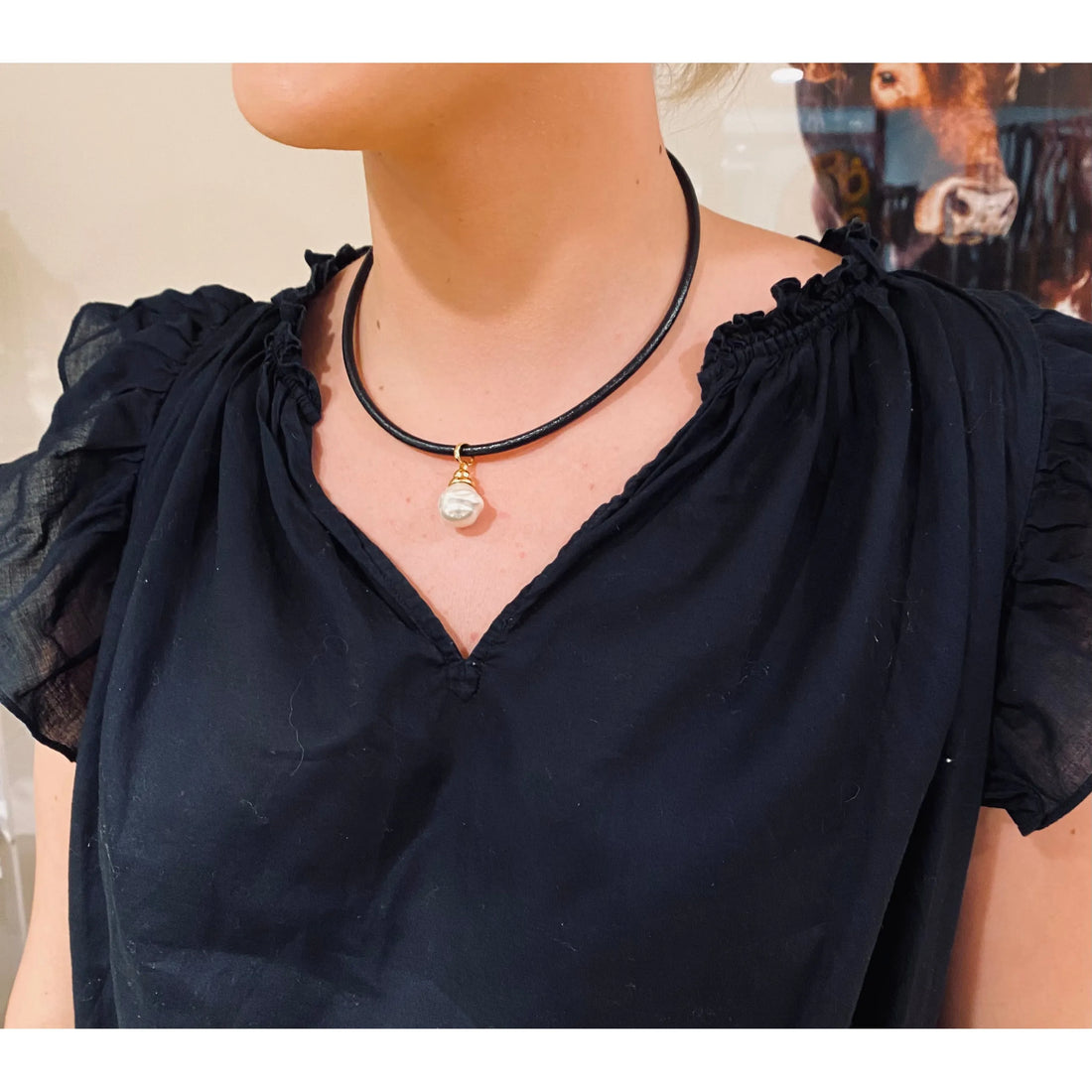 Spanish Pearl displayed on thick leather cord necklace with gold detail