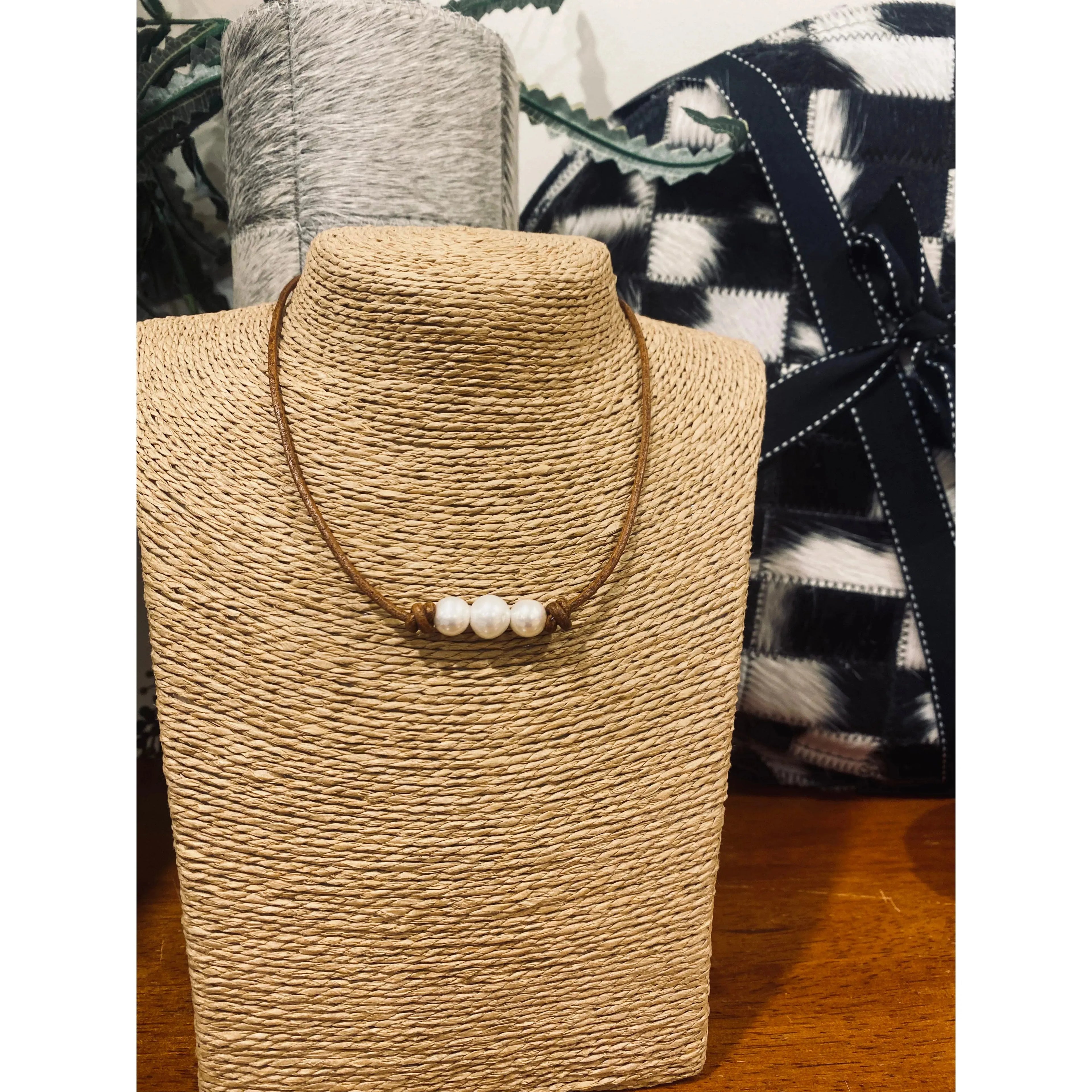 Pearls on dark tan leather