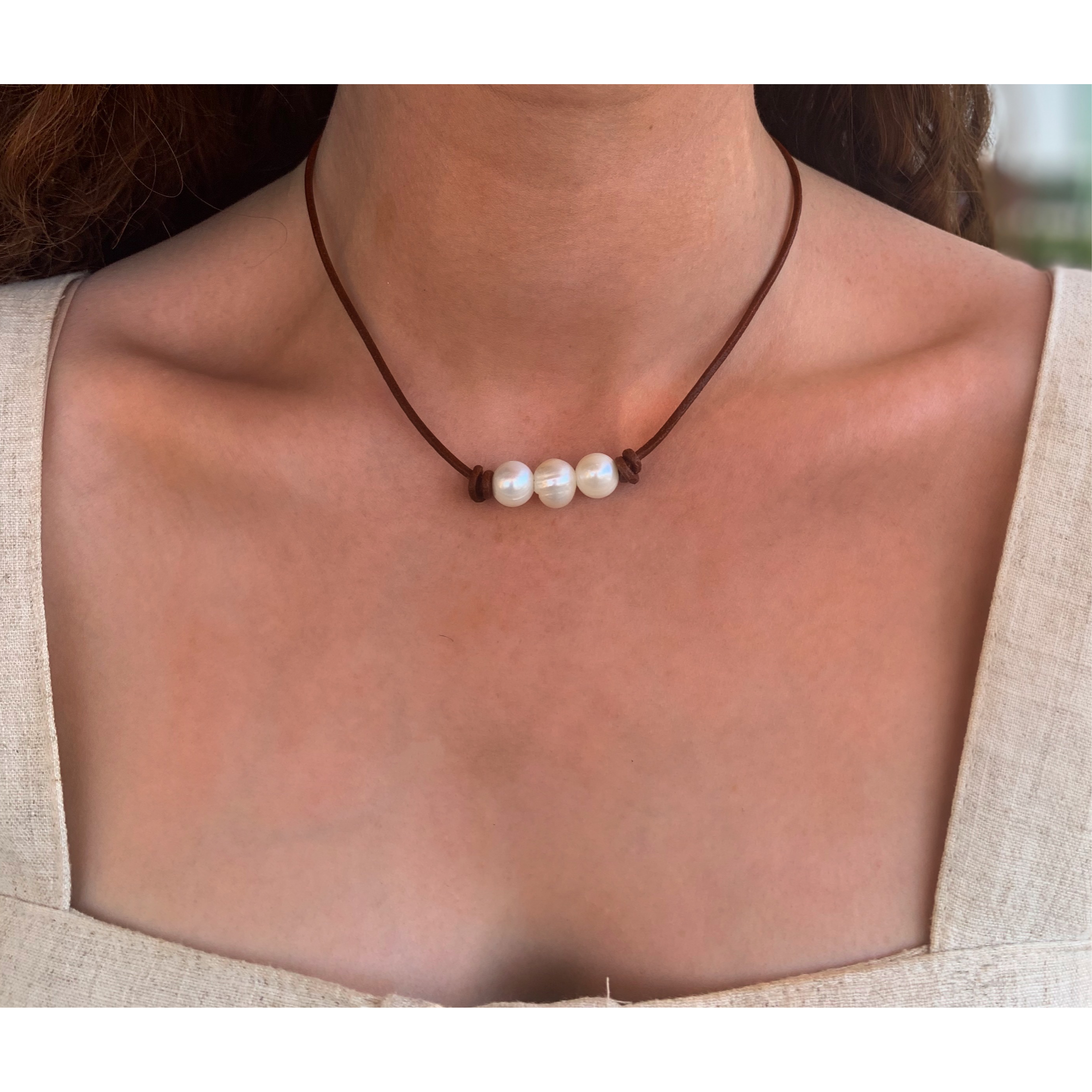 Pearls on dark tan leather