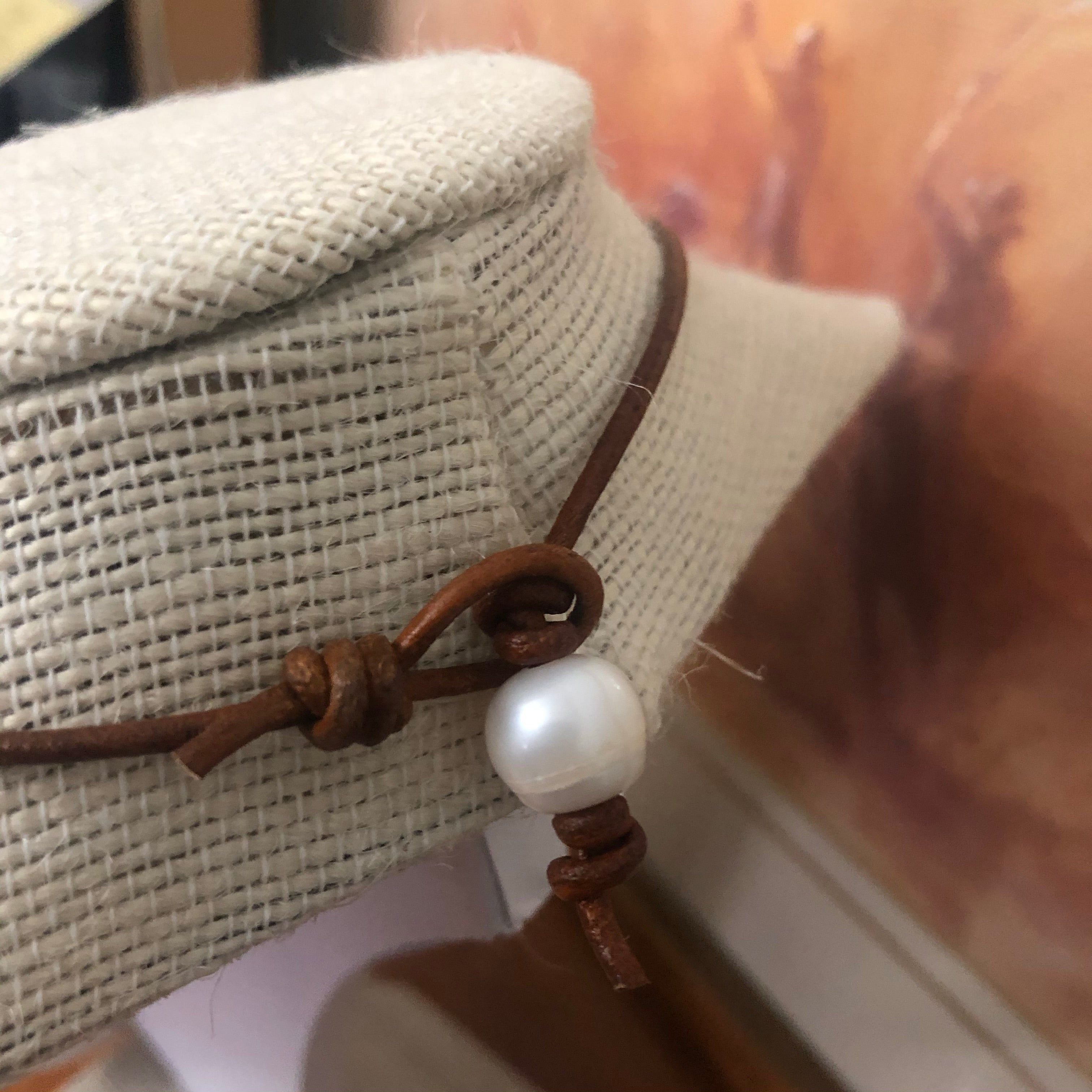 Pearls on dark tan leather