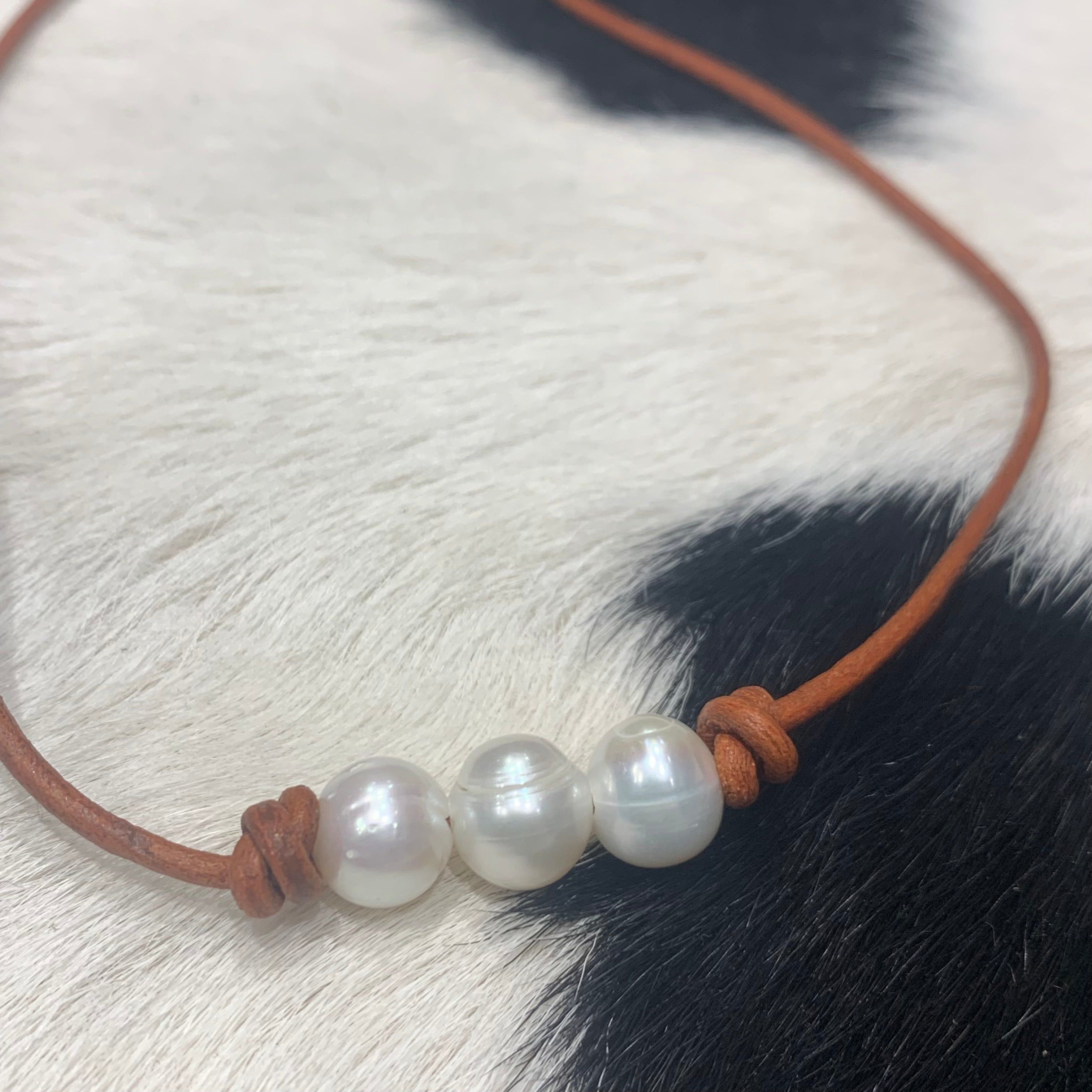 Three Pearls on red tan leather