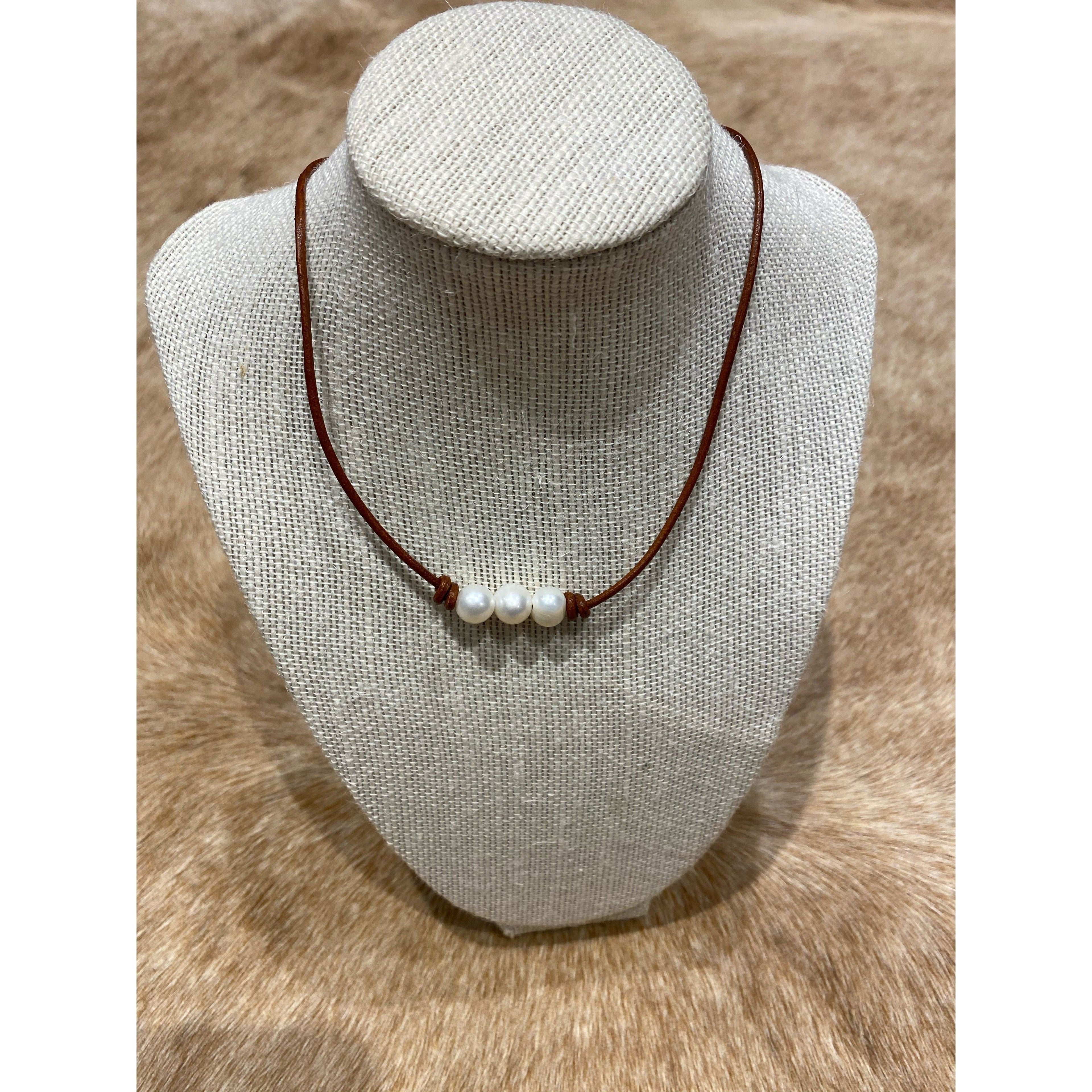 Pearls on dark tan leather