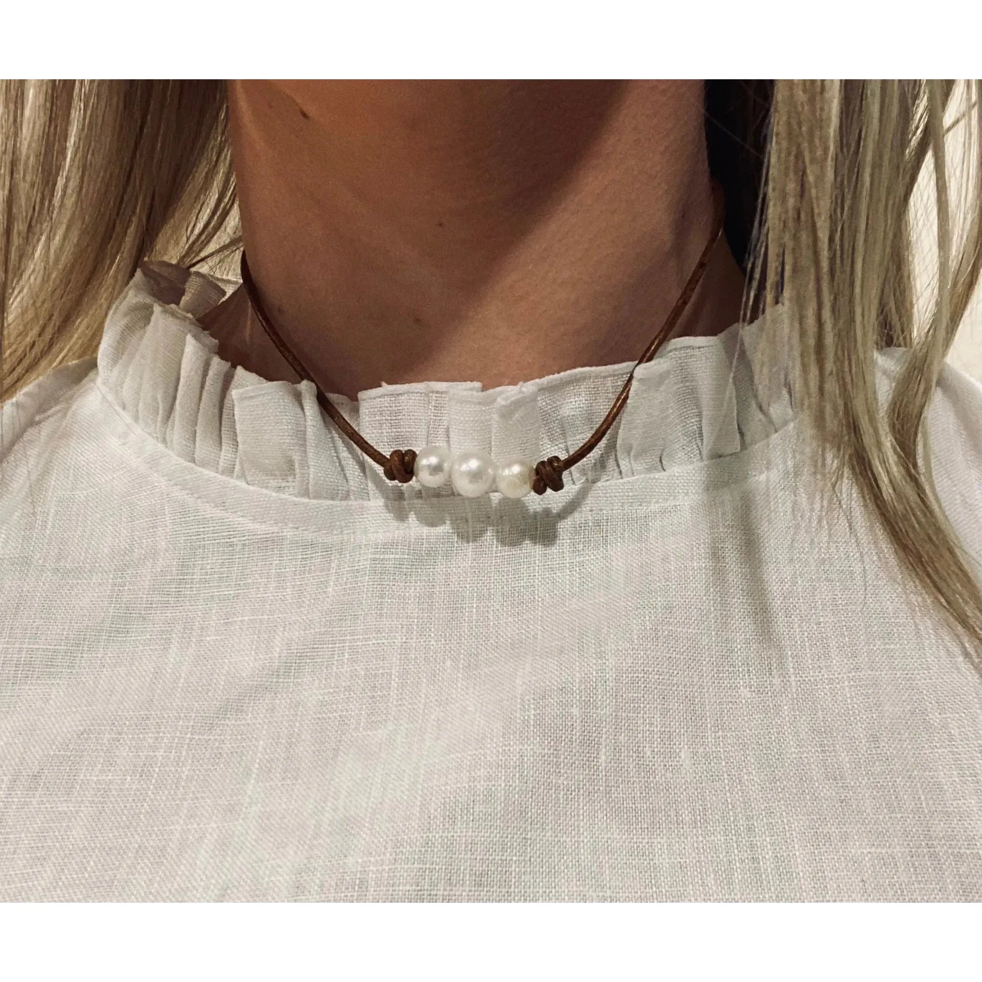 Pearls on dark tan leather