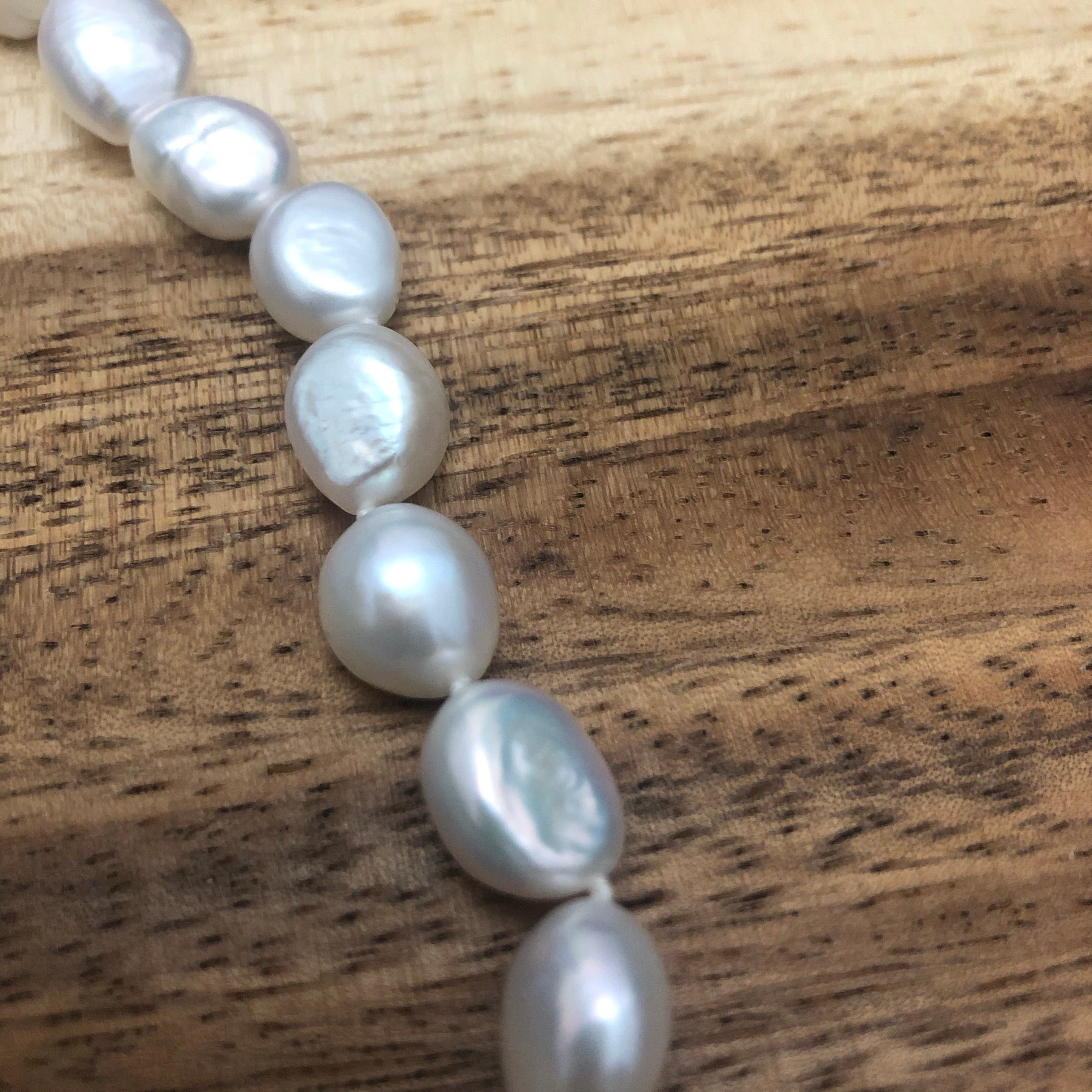 Freshwater potato pearl with silver fob.