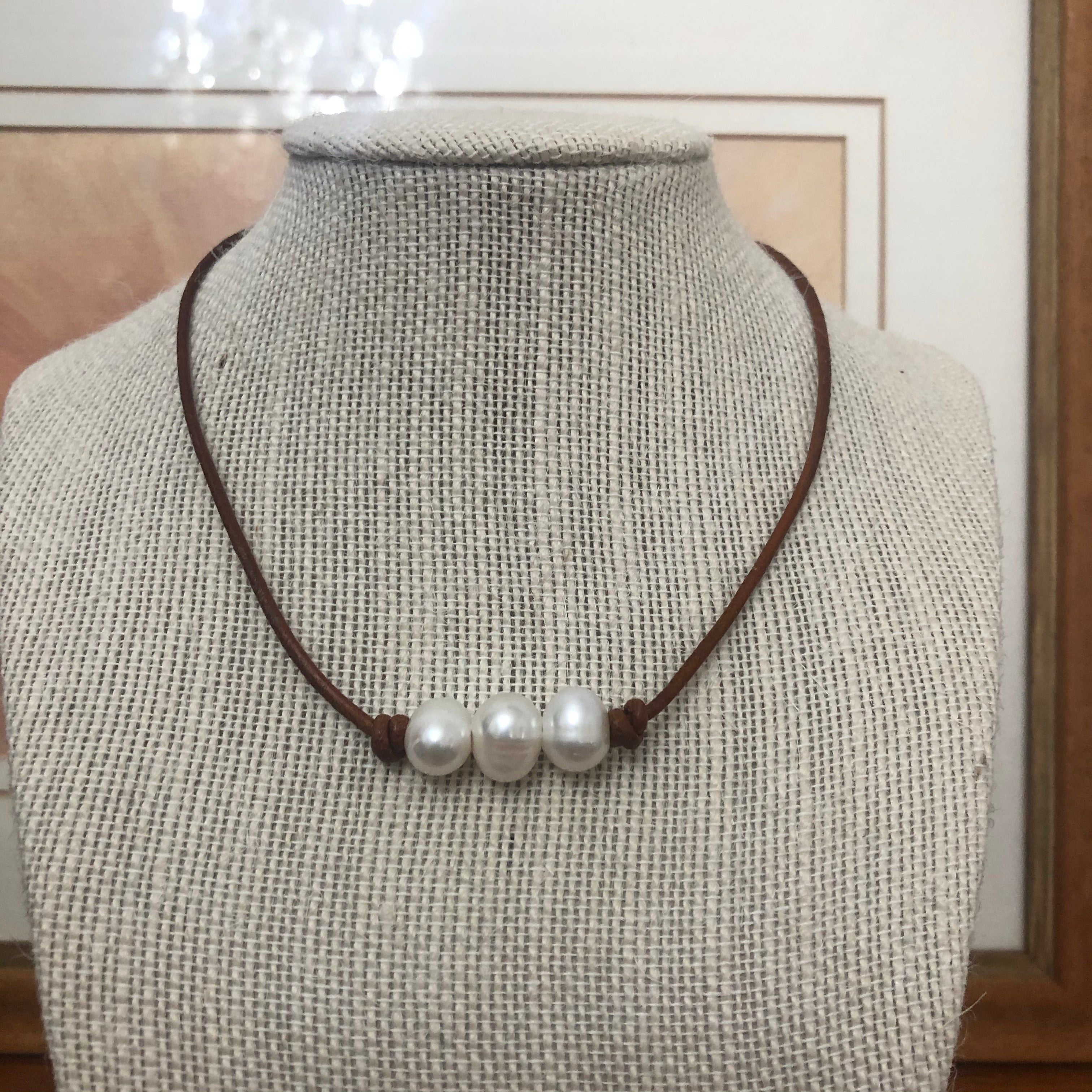 Pearls on dark tan leather