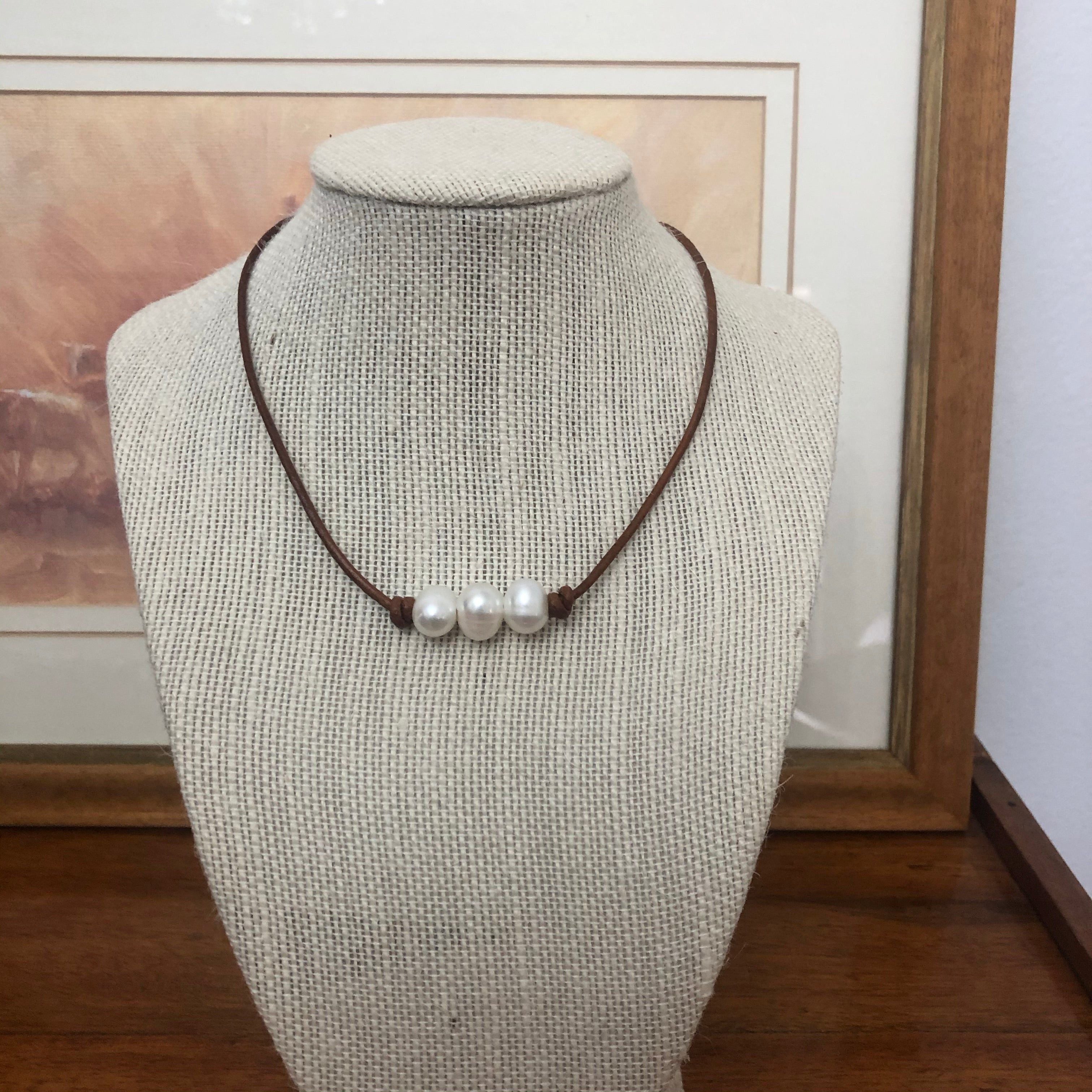 Pearls on dark tan leather