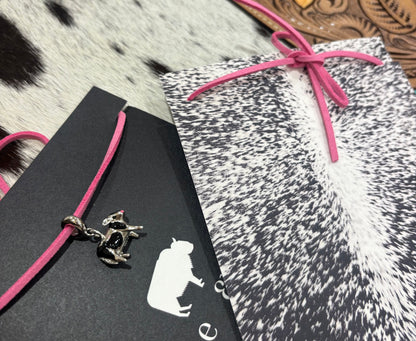 Silver Cows charm on pink leather lariat 