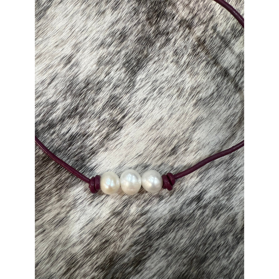 Pearls on maroon leather