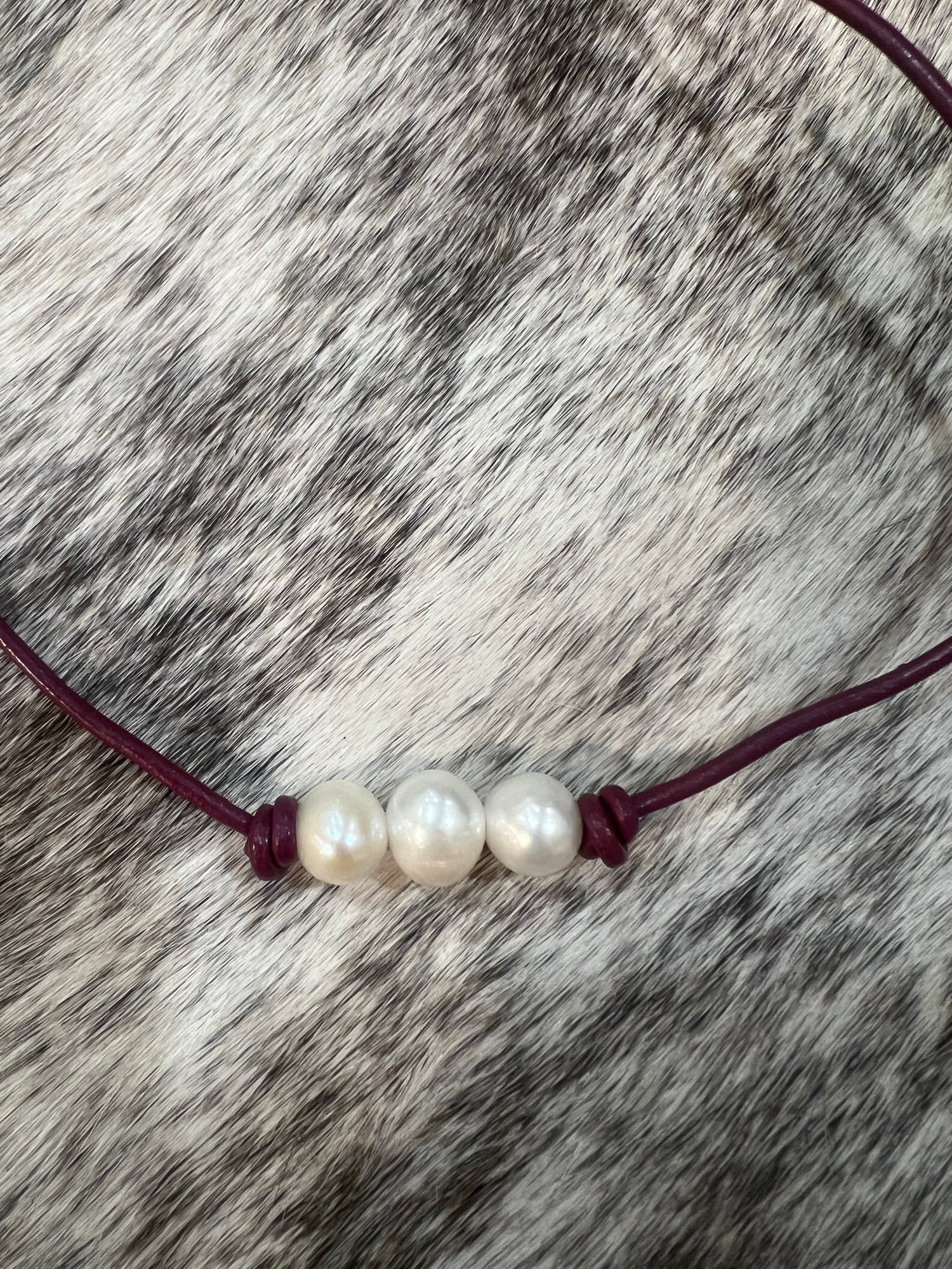 Pearls on maroon leather 