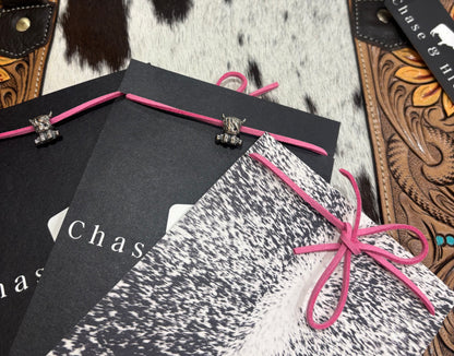 Silver Cows charm on pink leather lariat 