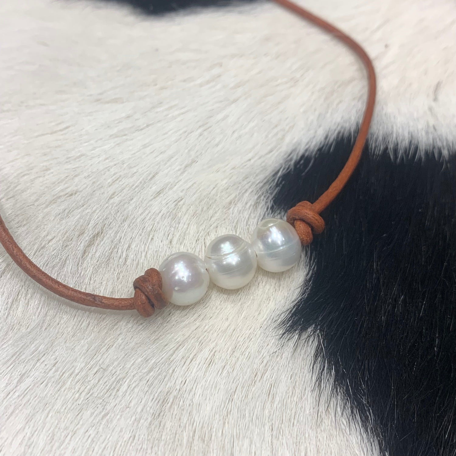 Three Pearls on red tan leather 