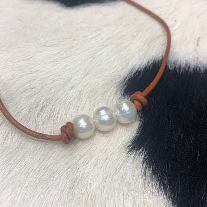 Three Pearls on red tan leather 