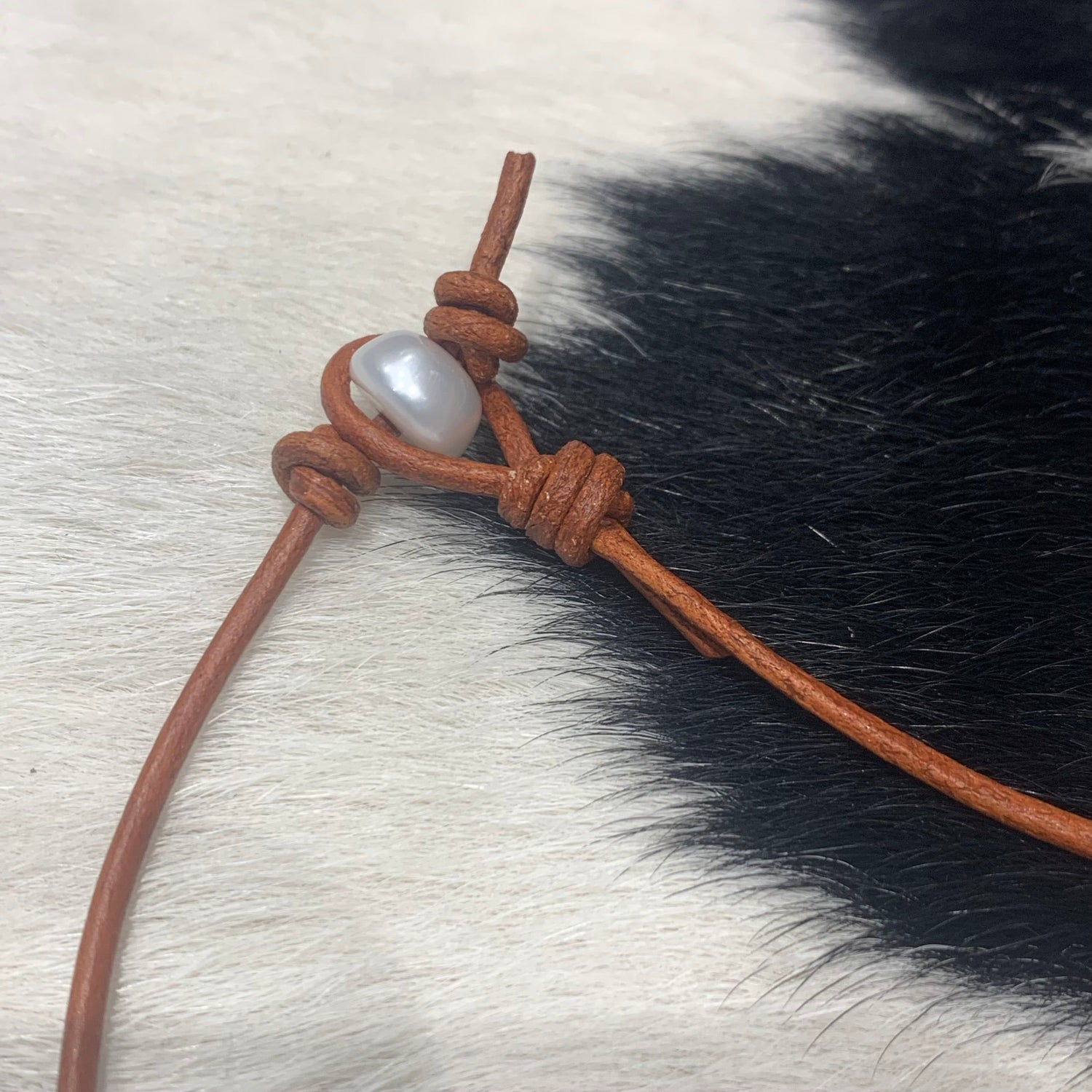 Three Pearls on red tan leather 