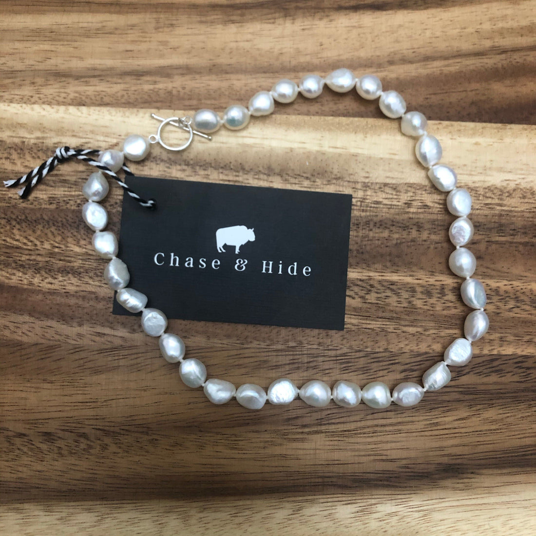 Freshwater potato pearl with silver fob.