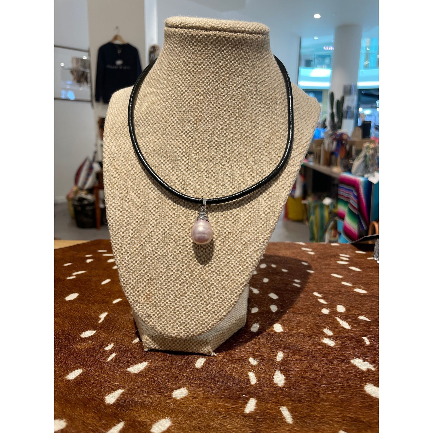 Blush Spanish Faux Pearl displayed on thick leather cord necklace with silver detail 