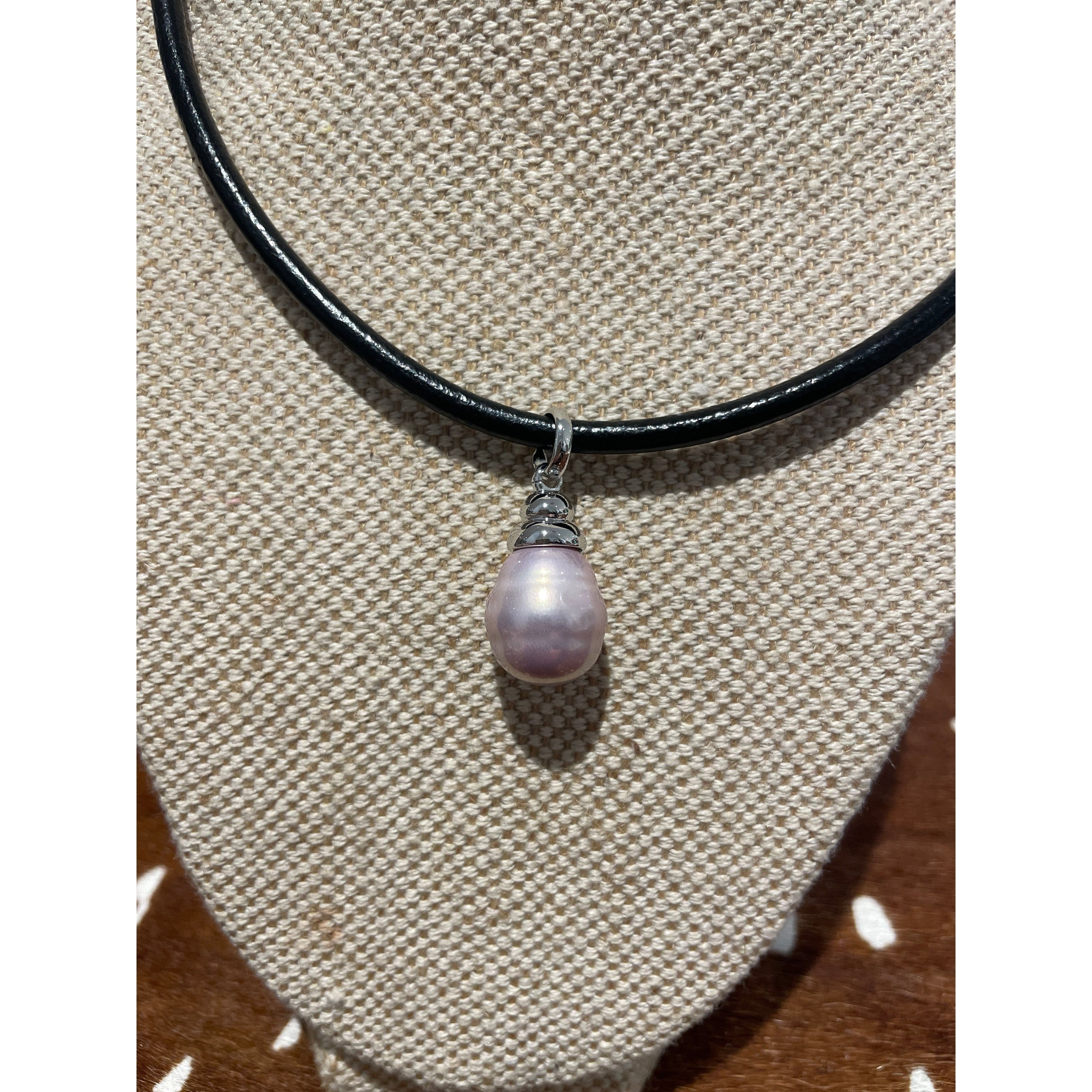 Blush Spanish Faux Pearl displayed on thick leather cord necklace with silver detail 